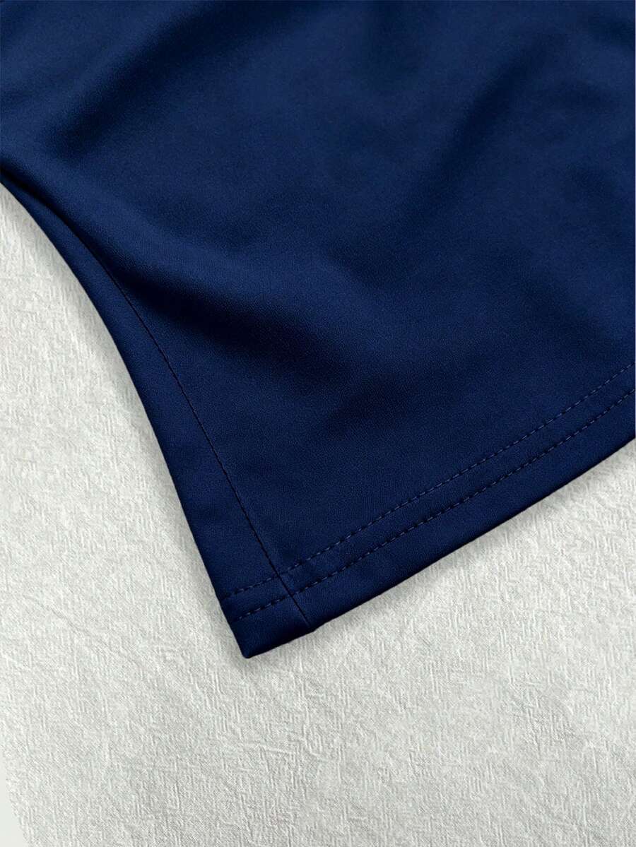 A women's solid slim fit camisole top with delicate contrast lace trim around the neckline and spaghetti straps.