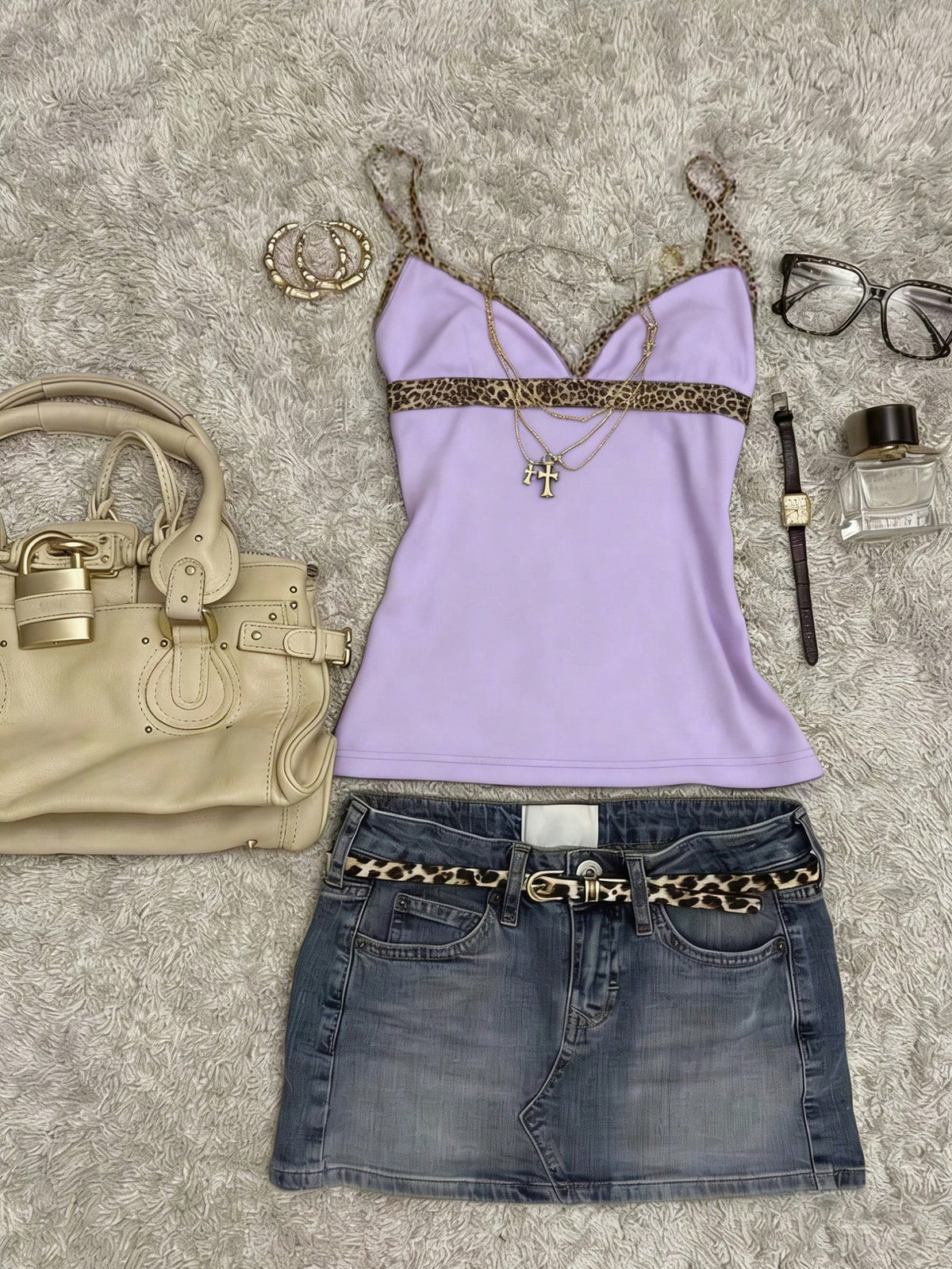 A women's solid slim fit camisole top with delicate contrast lace trim around the neckline and spaghetti straps.