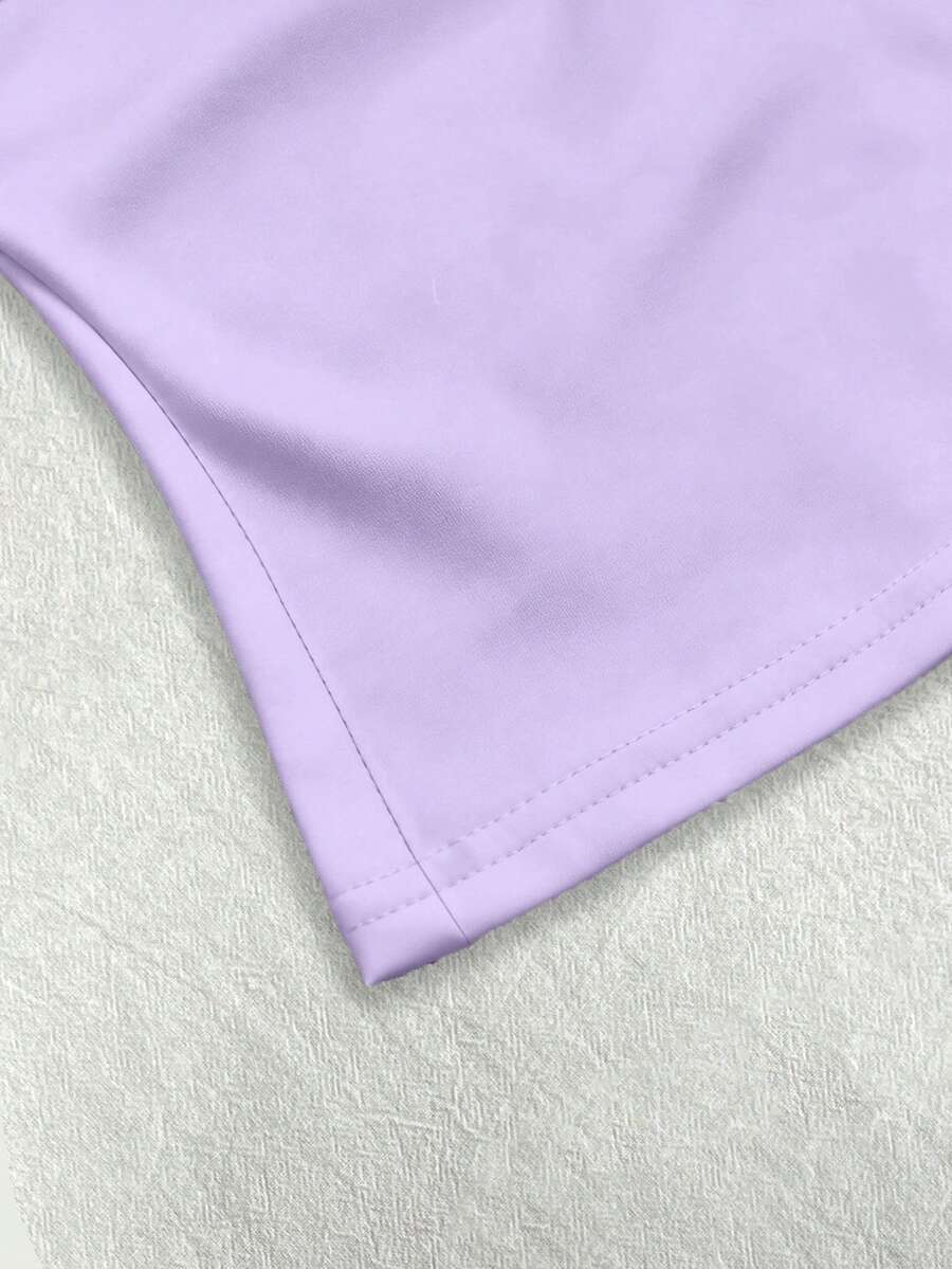 A women's solid slim fit camisole top with delicate contrast lace trim around the neckline and spaghetti straps.