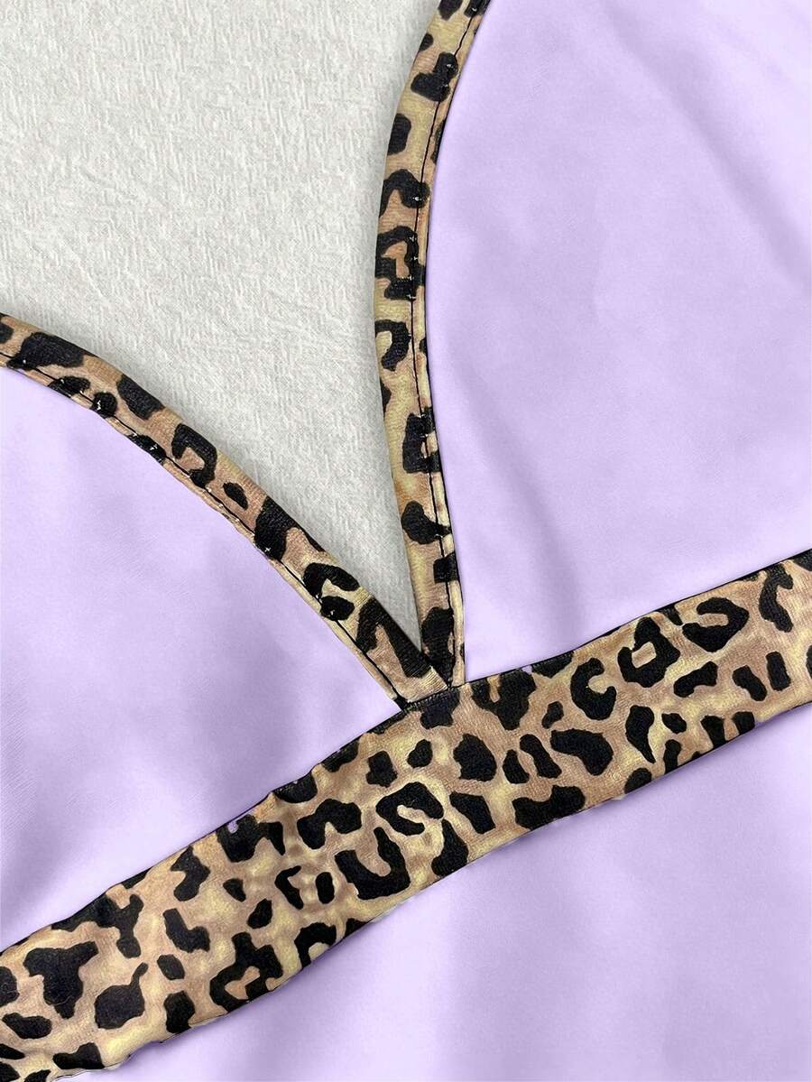 A women's solid slim fit camisole top with delicate contrast lace trim around the neckline and spaghetti straps.