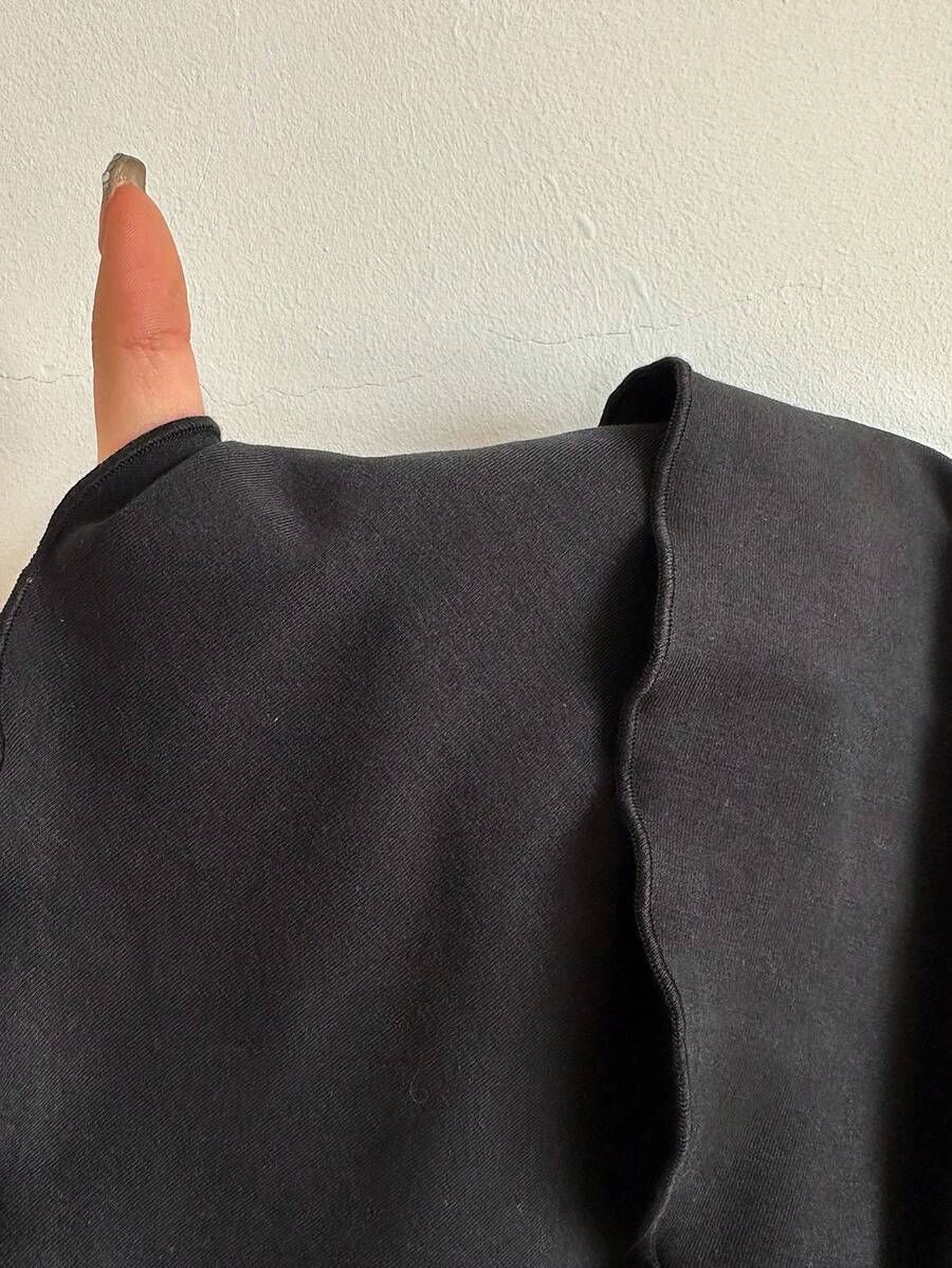 Black low waist knit mini skirt featuring a tiered ruffle hem and skinny high stretch fit.