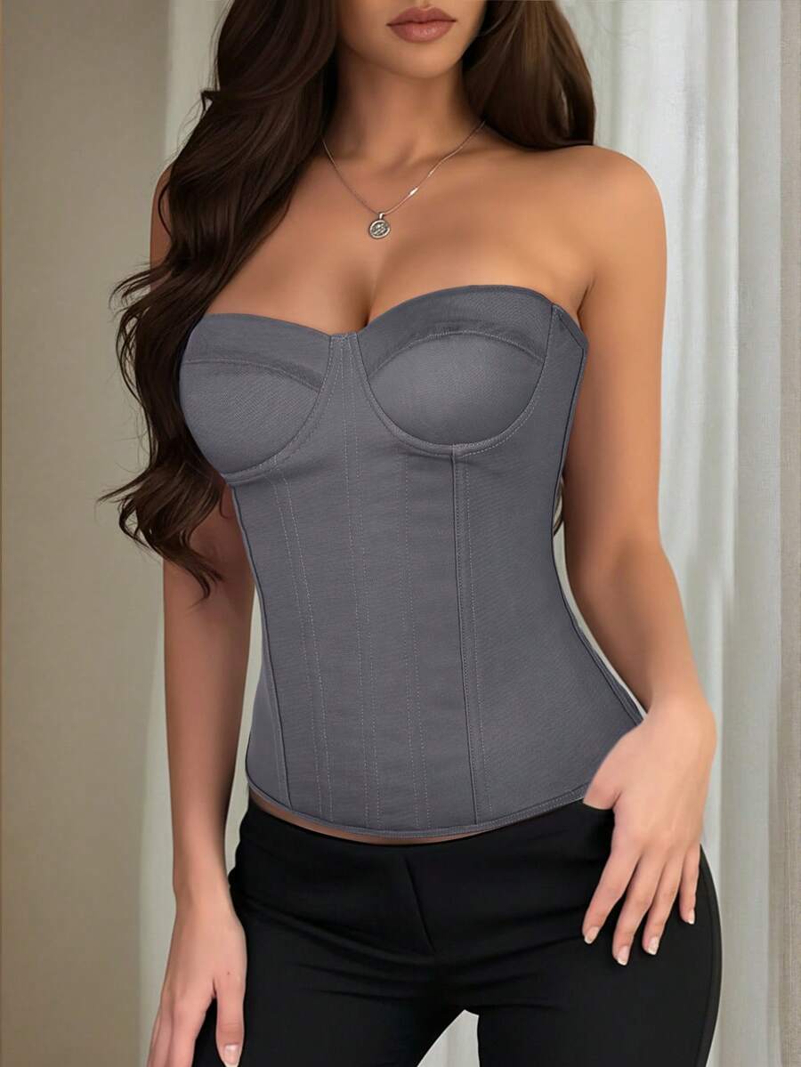 Black strapless corset top with boning, lace-up back, and a cropped slim-fit silhouette for women.