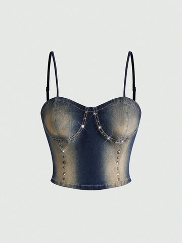 Women's medium wash denim camisole crop top featuring spaghetti straps, cup detailing, and rivet accents.