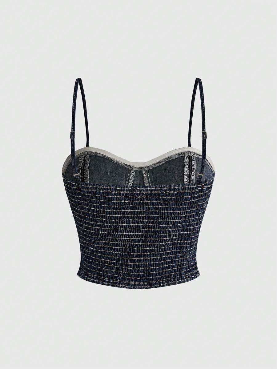 Women's medium wash denim camisole crop top featuring spaghetti straps, cup detailing, and rivet accents.