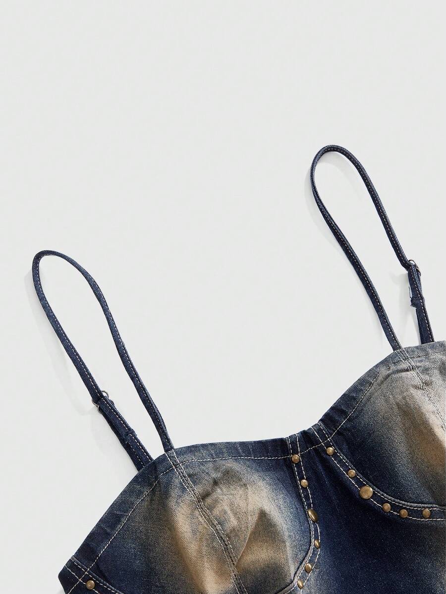 Women's medium wash denim camisole crop top featuring spaghetti straps, cup detailing, and rivet accents.