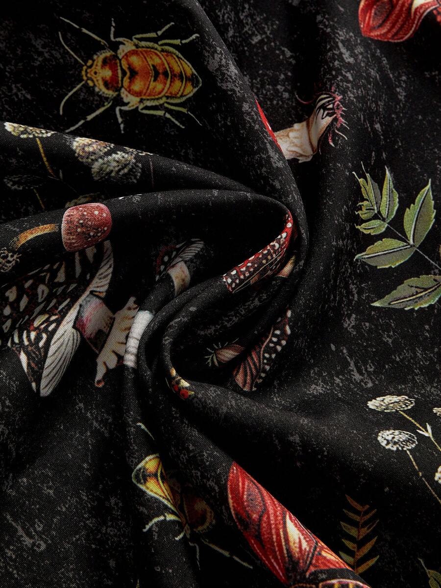 Black fairycore halter backless mini dress with mushroom, moth, and plant print featuring a high waist and flared hem.