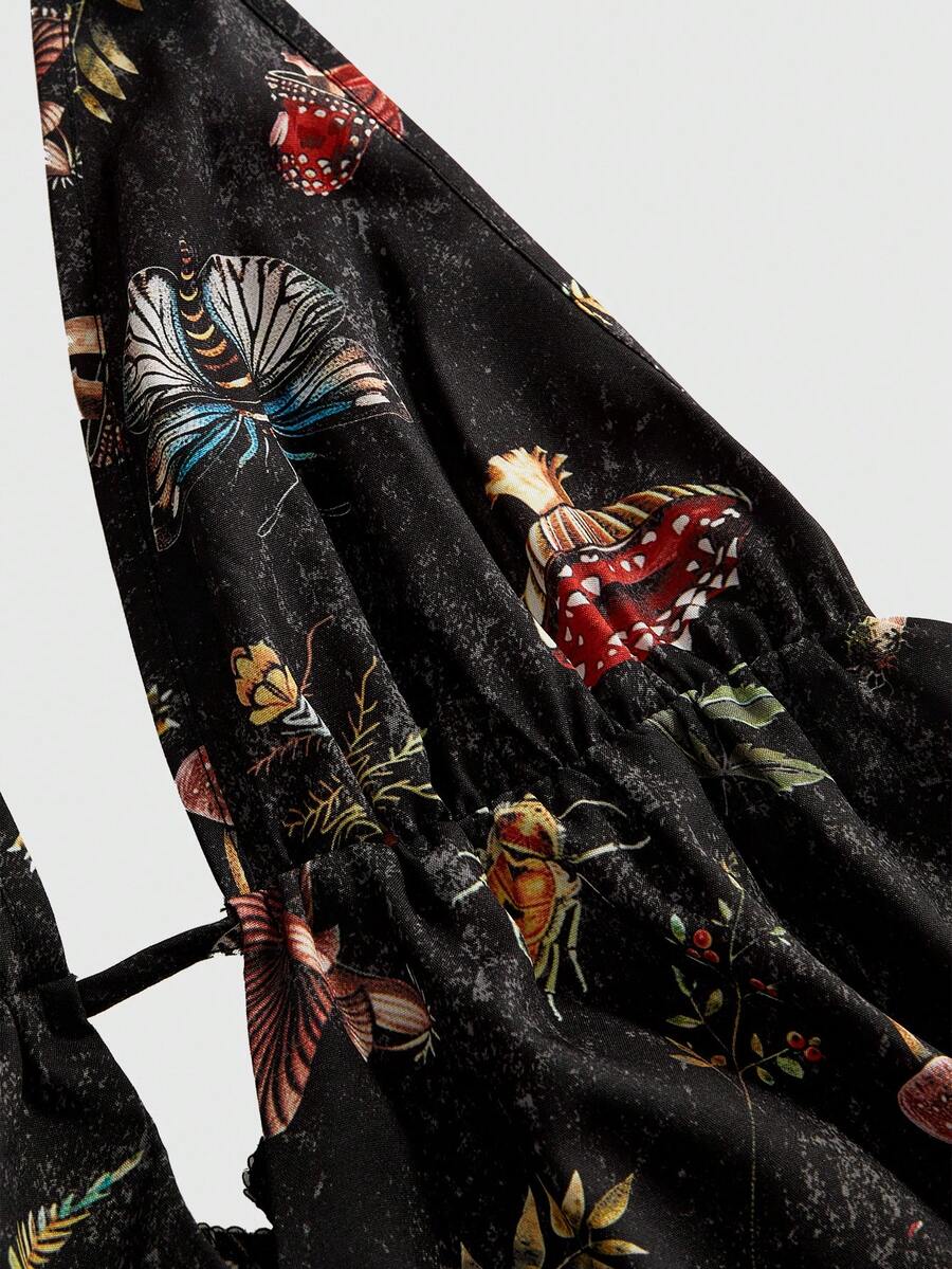 Black fairycore halter backless mini dress with mushroom, moth, and plant print featuring a high waist and flared hem.