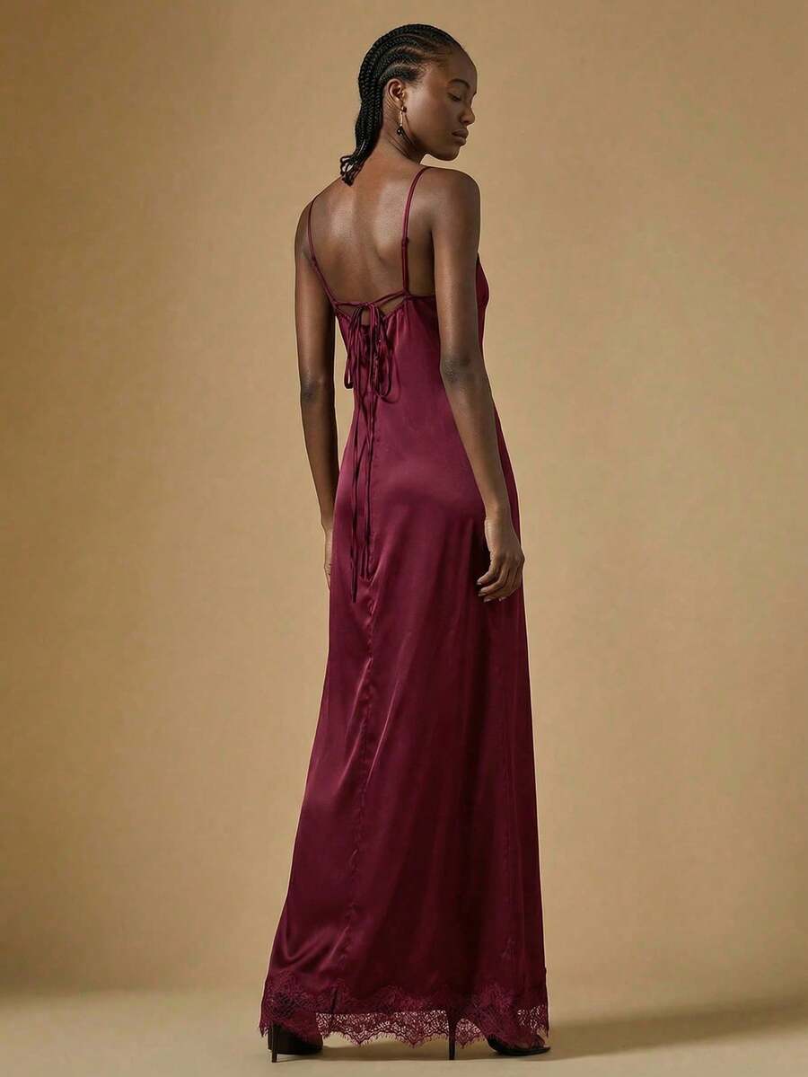 Women's black lace split satin long dress featuring spaghetti straps, asymmetrical slit hem, and matching arm sleeves.