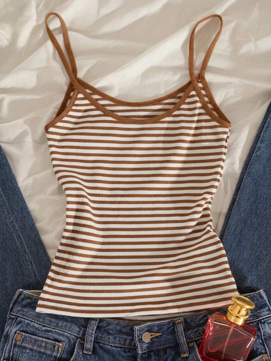 Women's pink striped crop camisole featuring criss cross spaghetti straps and slim fit design.