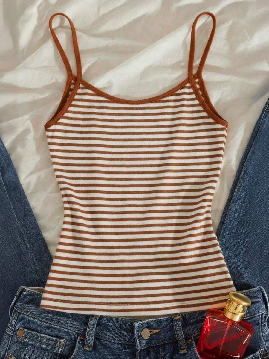 Women's pink striped crop camisole featuring criss cross spaghetti straps and slim fit design.