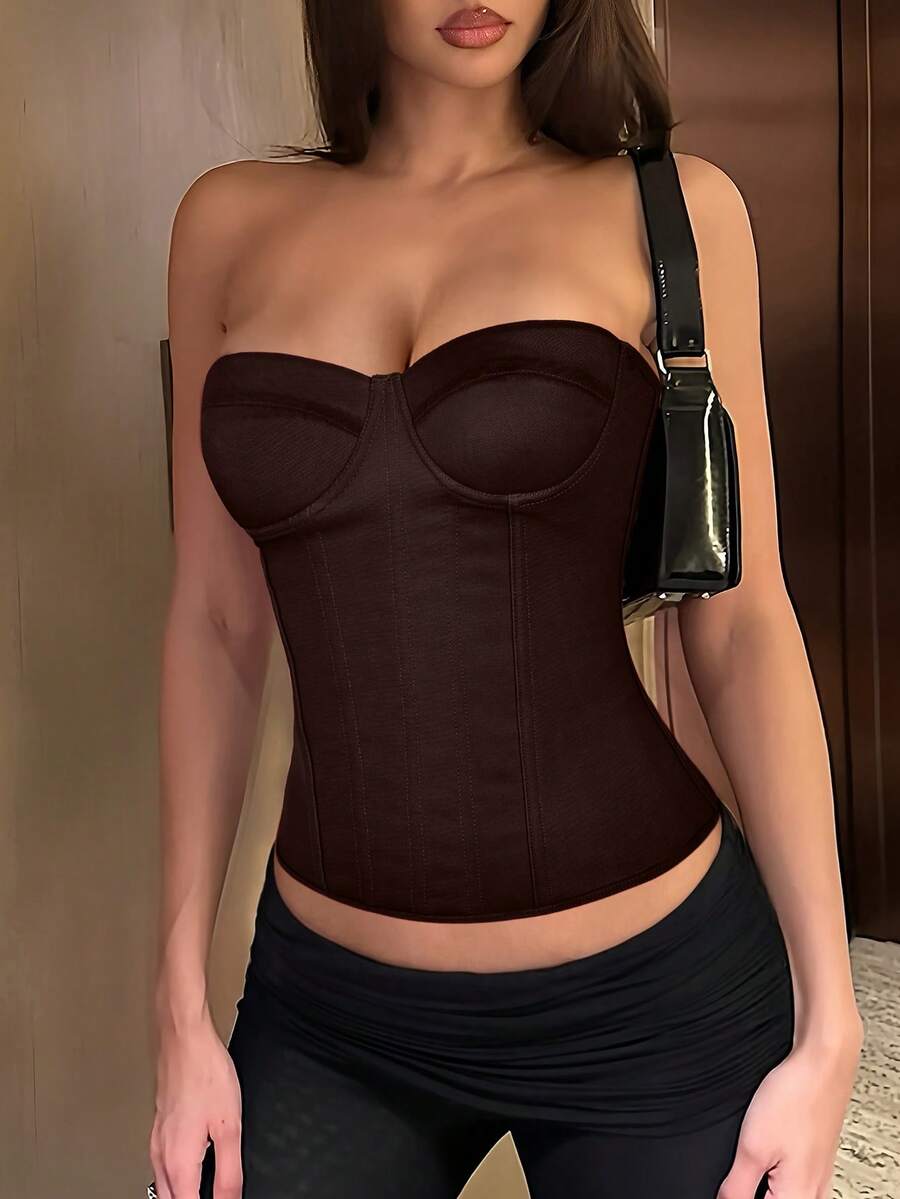 Black strapless corset top with boning, lace-up back, and a cropped slim-fit silhouette for women.