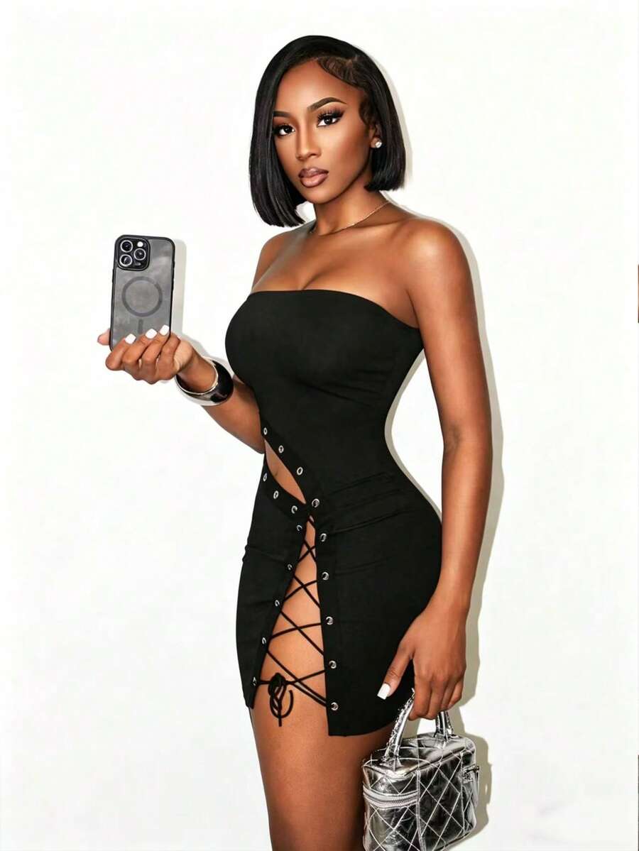 Women's black strapless bodycon mini dress featuring an asymmetrical lace-up design with grommet eyelets and a slim pencil fit.
