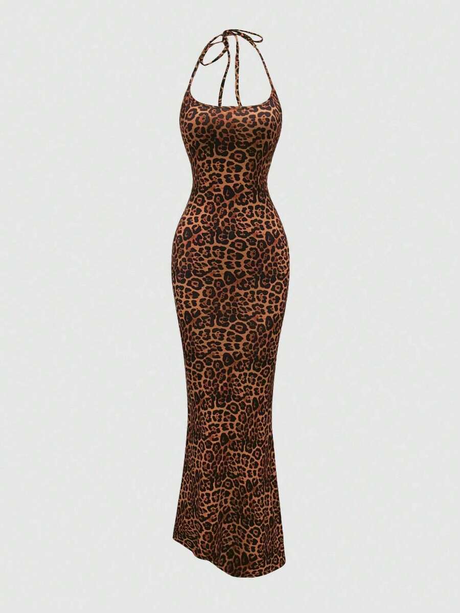 Women wearing a sleeveless leopard print halter neck maxi bodycon dress with a side slit