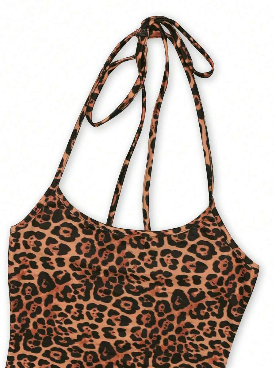 Women wearing a sleeveless leopard print halter neck maxi bodycon dress with a side slit