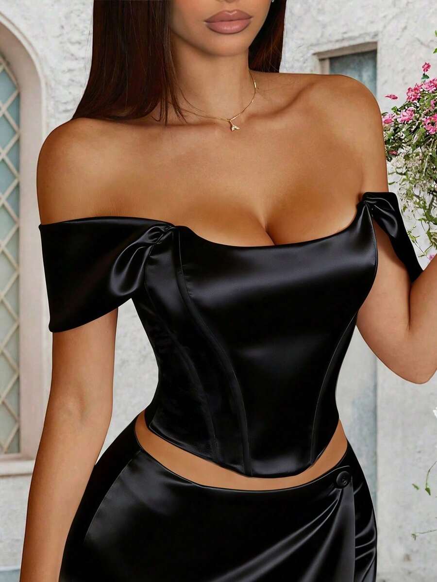 Women's white satin corset crop top with off-shoulder neckline, backless cut, and asymmetrical hem.
