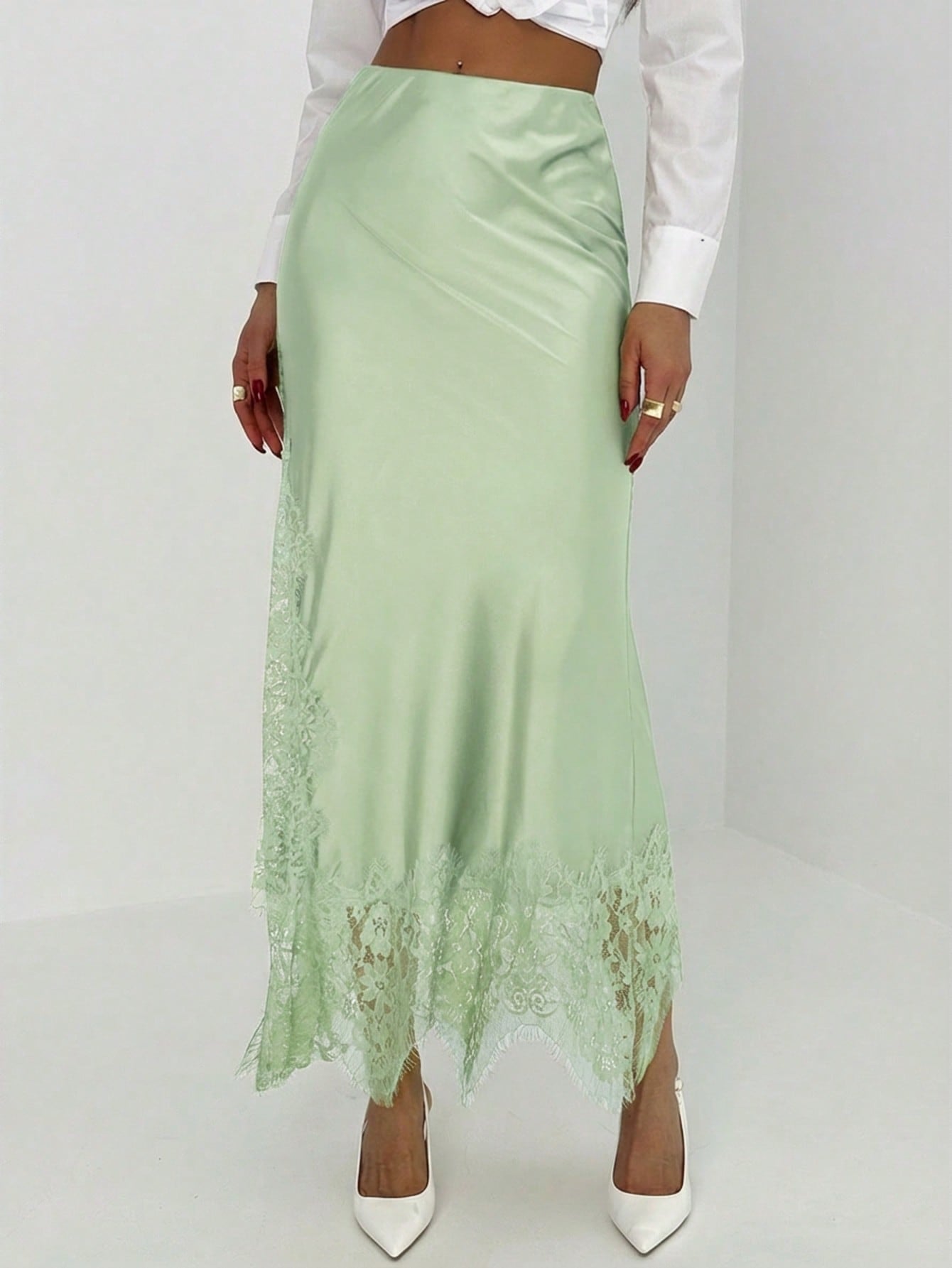 Women's elegant black lace patchwork mermaid maxi skirt featuring asymmetrical contrast lace design and low waist fit.