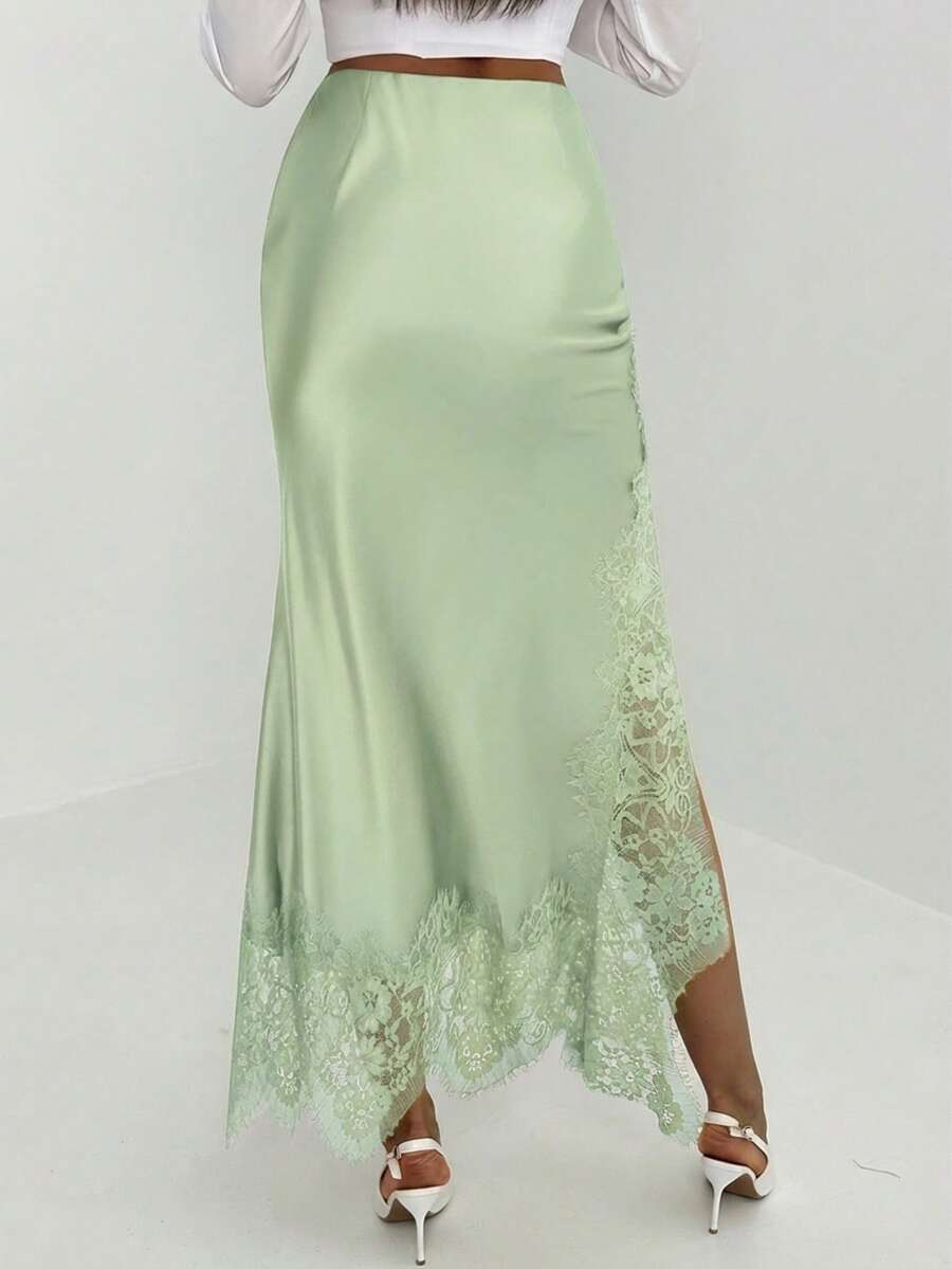 Women's elegant black lace patchwork mermaid maxi skirt featuring asymmetrical contrast lace design and low waist fit.