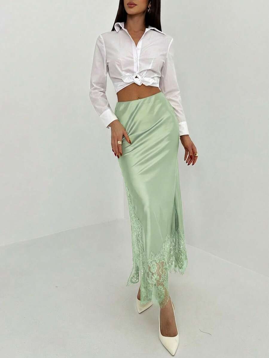 Women's elegant black lace patchwork mermaid maxi skirt featuring asymmetrical contrast lace design and low waist fit.