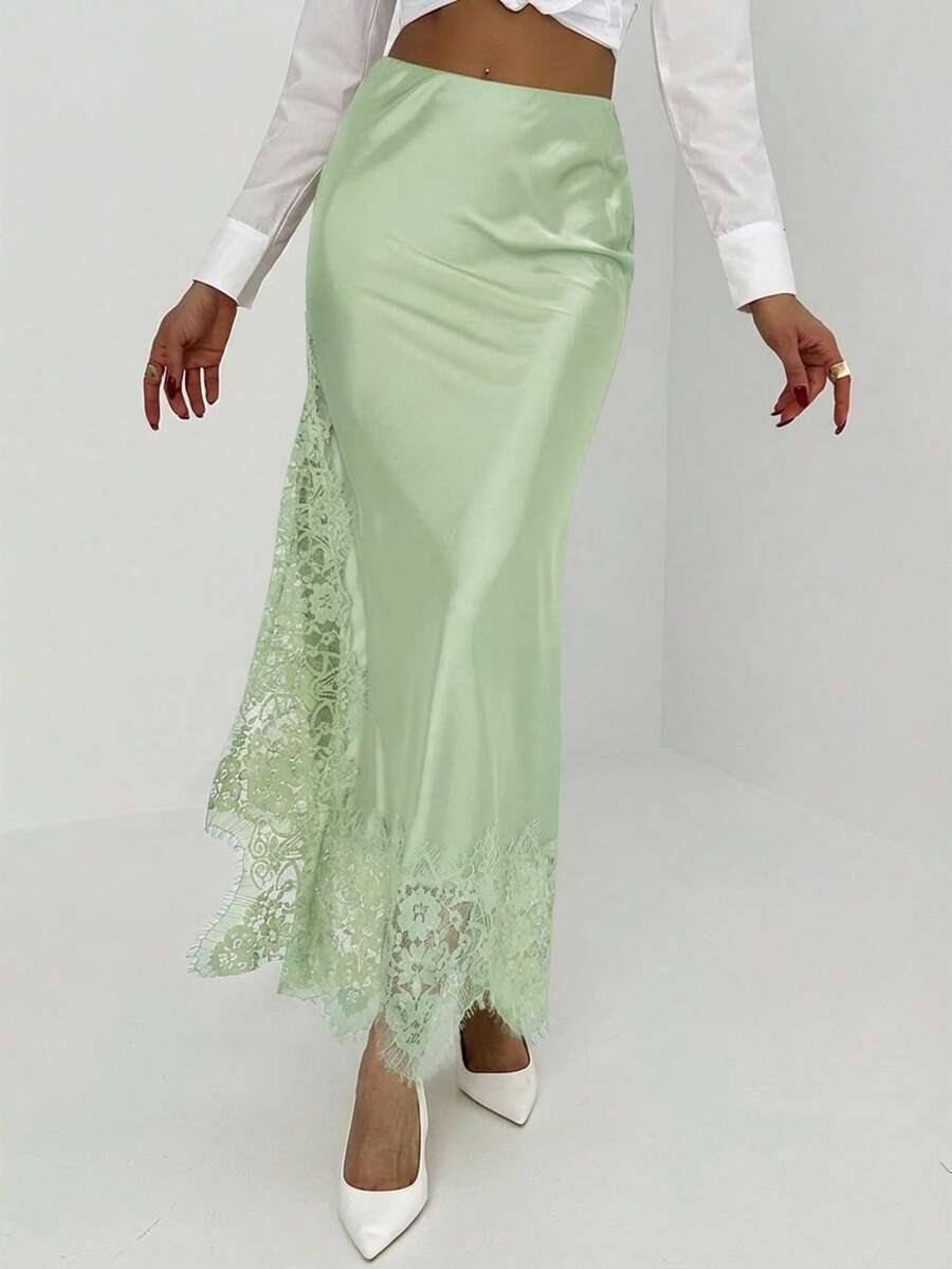 Women's elegant black lace patchwork mermaid maxi skirt featuring asymmetrical contrast lace design and low waist fit.