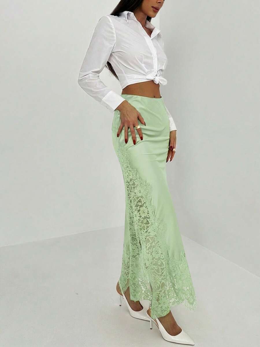 Women's elegant black lace patchwork mermaid maxi skirt featuring asymmetrical contrast lace design and low waist fit.