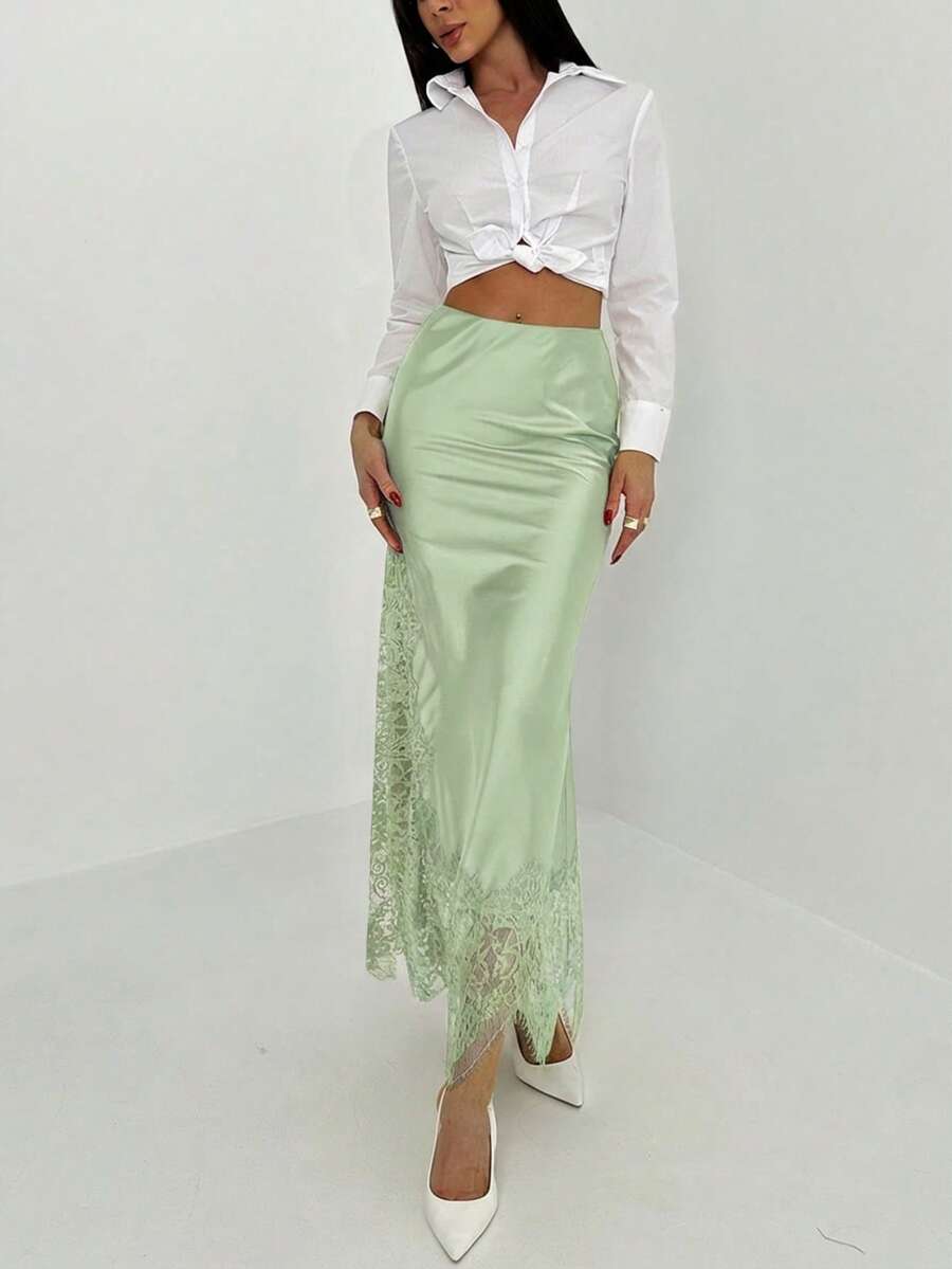 Women's elegant black lace patchwork mermaid maxi skirt featuring asymmetrical contrast lace design and low waist fit.
