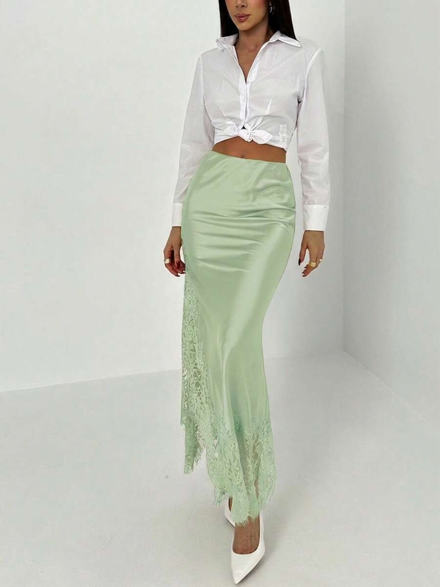 Women's elegant black lace patchwork mermaid maxi skirt featuring asymmetrical contrast lace design and low waist fit.