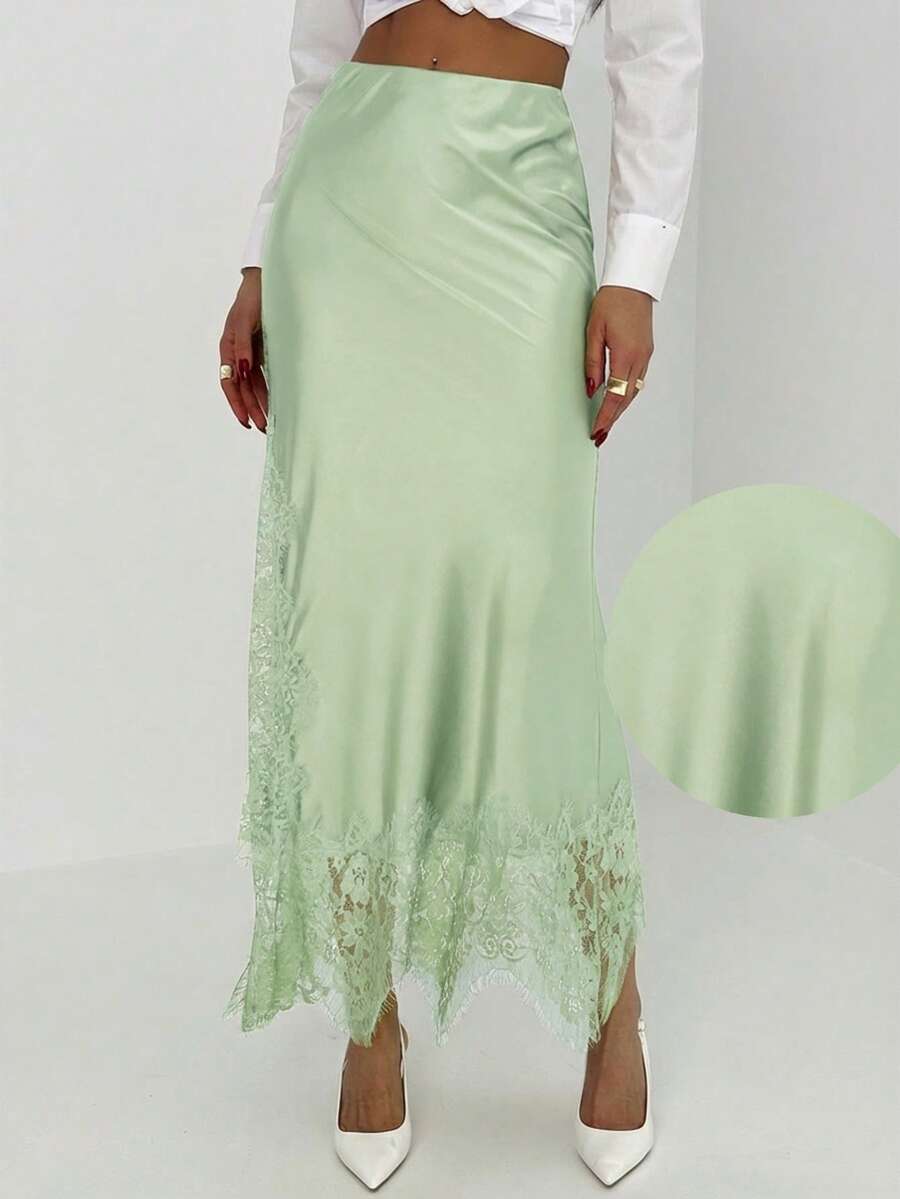 Women's elegant black lace patchwork mermaid maxi skirt featuring asymmetrical contrast lace design and low waist fit.