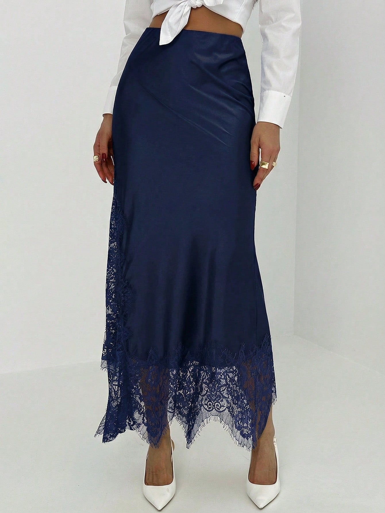 Women's elegant black lace patchwork mermaid maxi skirt featuring asymmetrical contrast lace design and low waist fit.