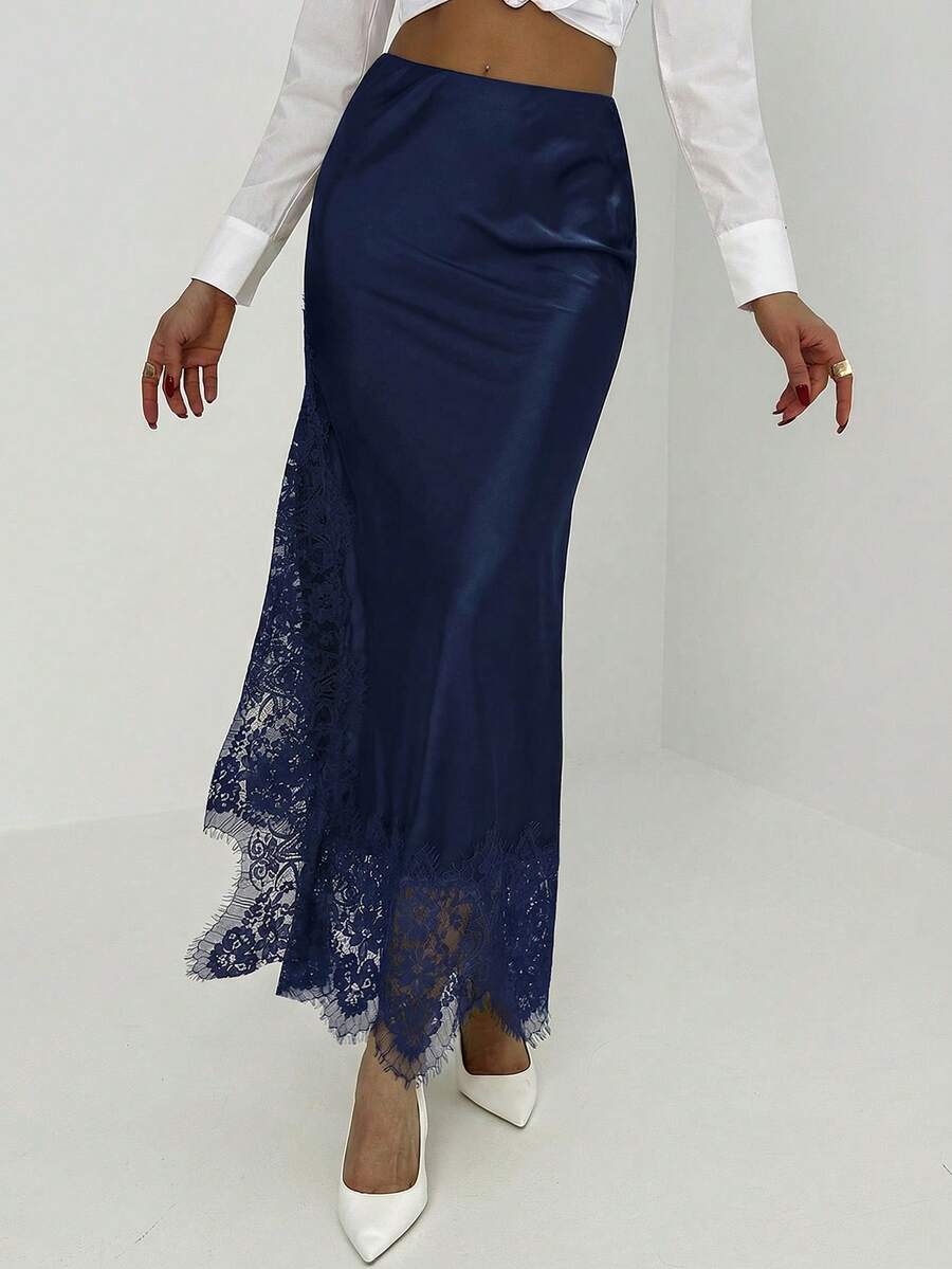 Women's elegant black lace patchwork mermaid maxi skirt featuring asymmetrical contrast lace design and low waist fit.