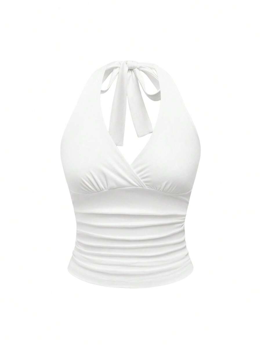 Women's halter crop tank top featuring a backless silhouette and ruched detailing in a slim fit design.