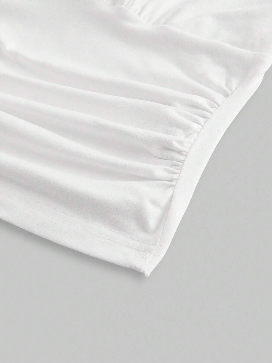 Women's halter crop tank top featuring a backless silhouette and ruched detailing in a slim fit design.
