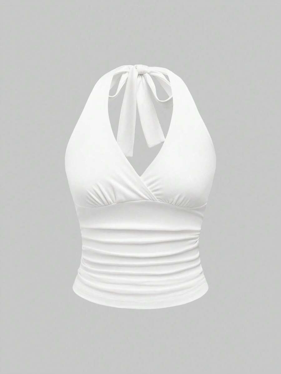 Women's halter crop tank top featuring a backless silhouette and ruched detailing in a slim fit design.