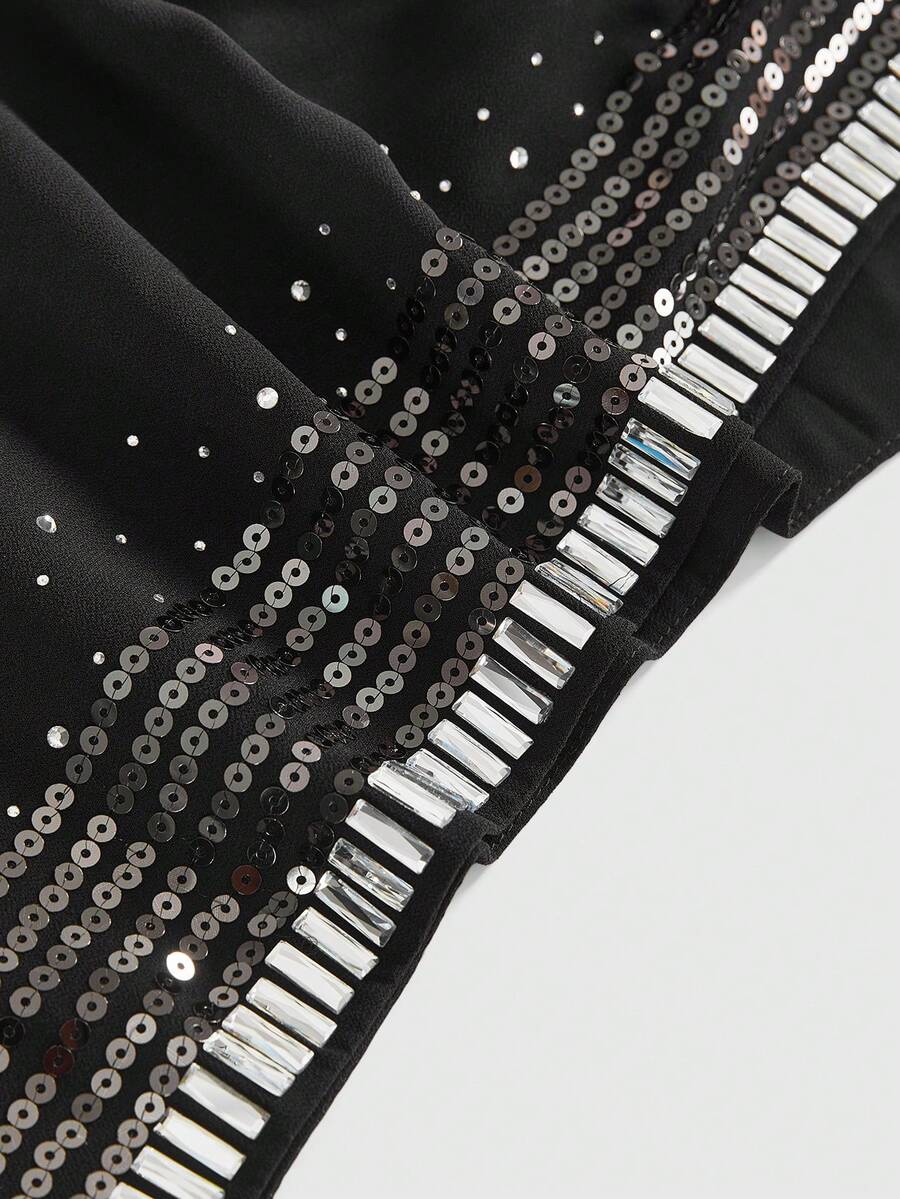 Women wearing a black Y2K draped halter neck backless sequin crop top crafted from semi-sheer chiffon fabric.
