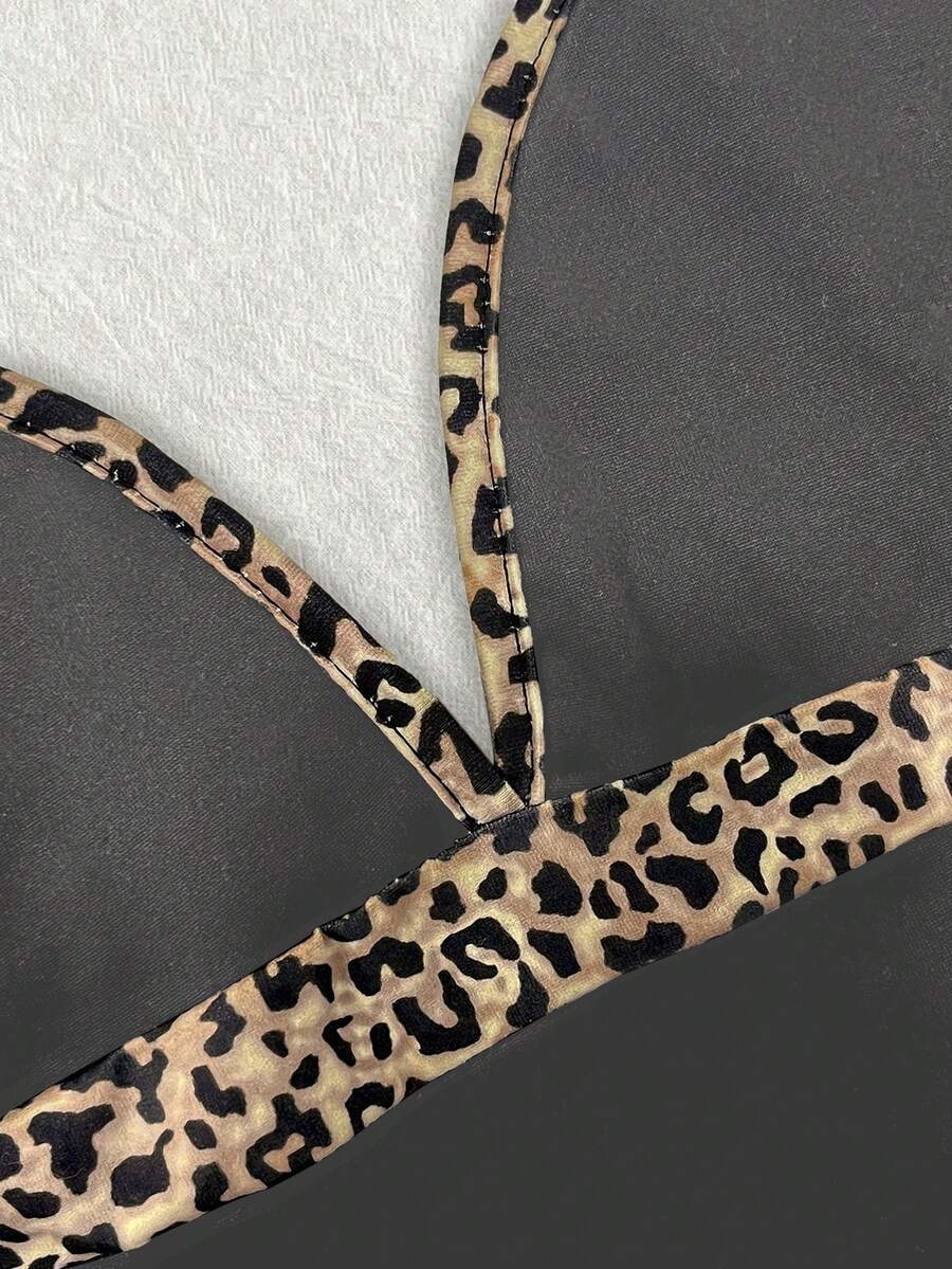 A women's solid slim fit camisole top with delicate contrast lace trim around the neckline and spaghetti straps.