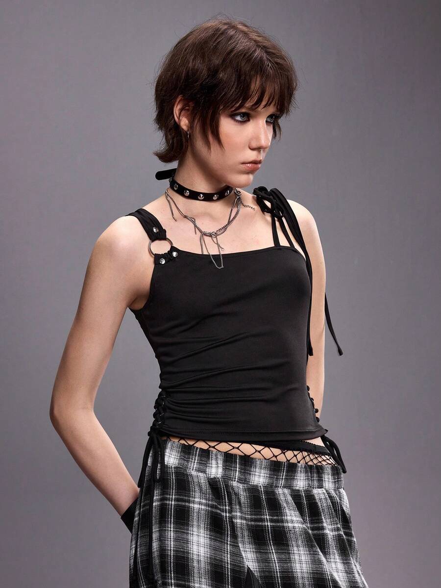 Women's black asymmetrical shoulder tie cami top with metallic ring detail and slim fit design.