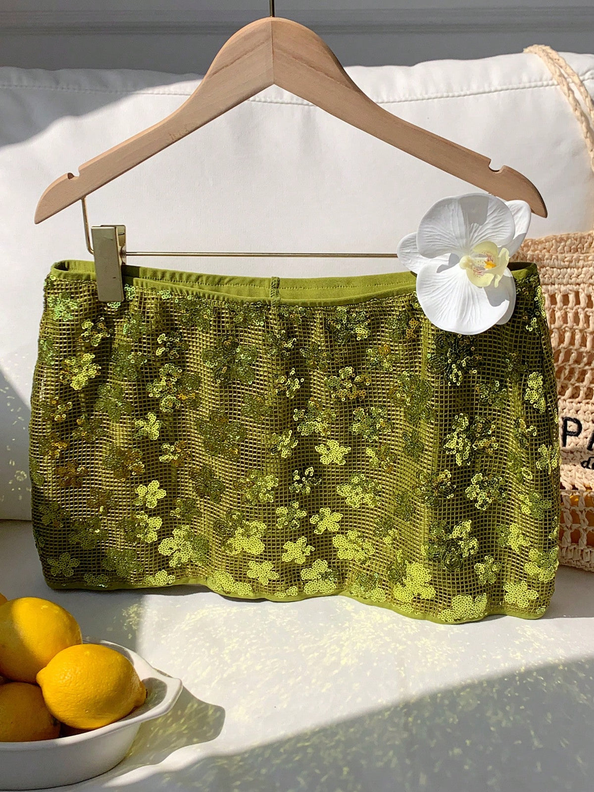 Women's white 100% cotton low waist mini skirt featuring a tropical print and zipper detail.