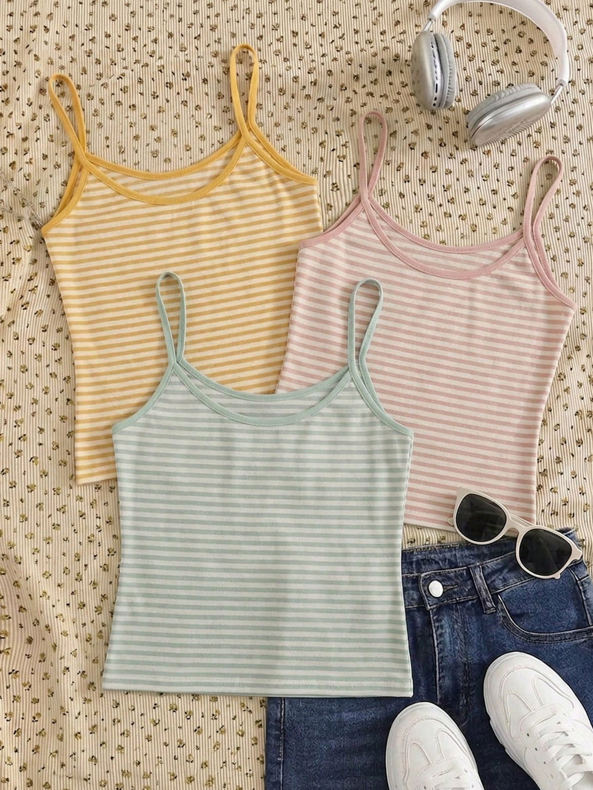 Women's pink striped crop camisole featuring criss cross spaghetti straps and slim fit design.