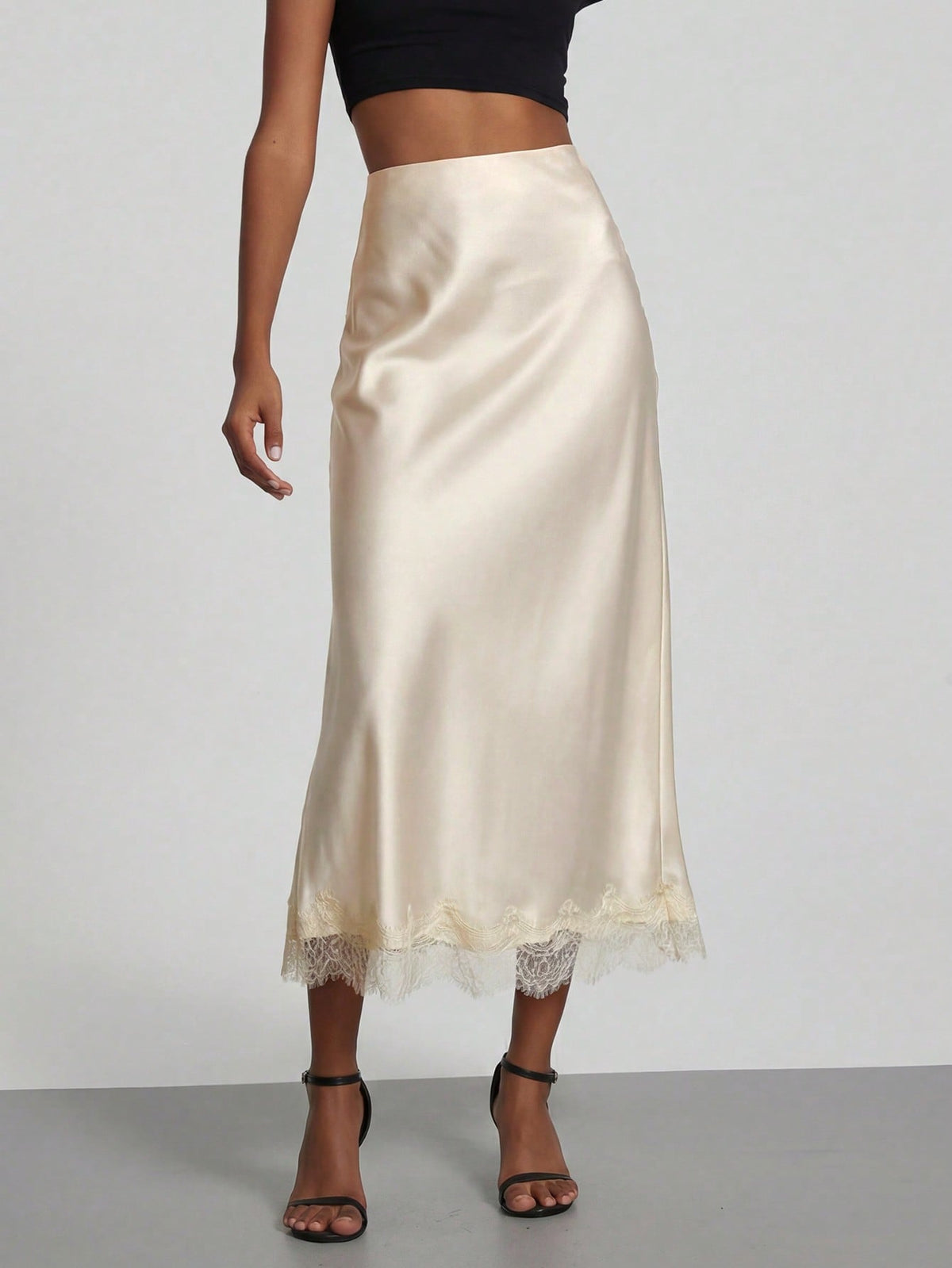Women's black lace patchwork satin skirt featuring a long bodycon silhouette and natural mid waist design.
