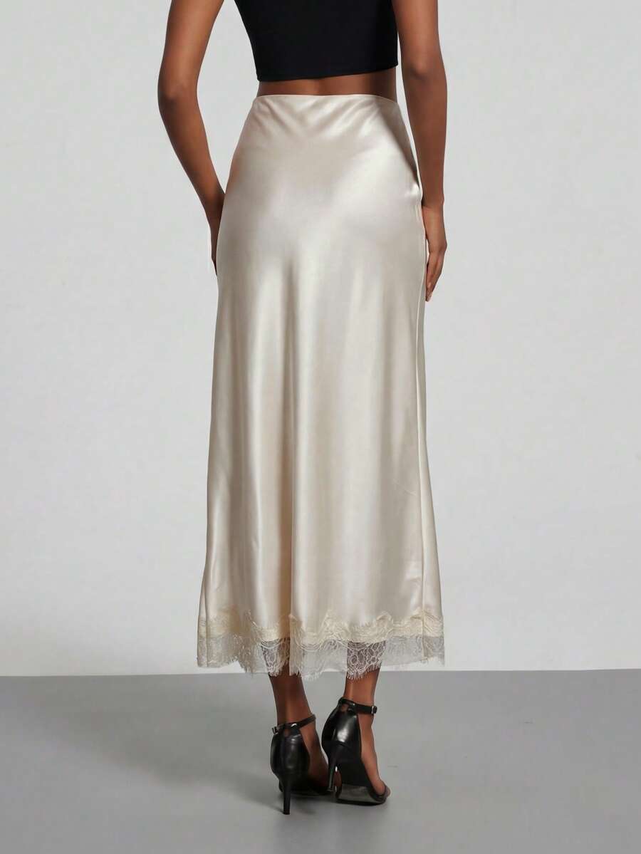 Women's black lace patchwork satin skirt featuring a long bodycon silhouette and natural mid waist design.