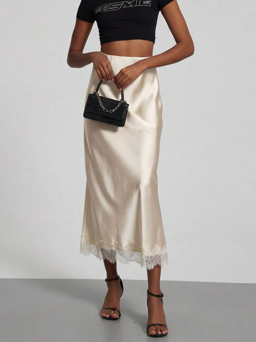 Women's black lace patchwork satin skirt featuring a long bodycon silhouette and natural mid waist design.