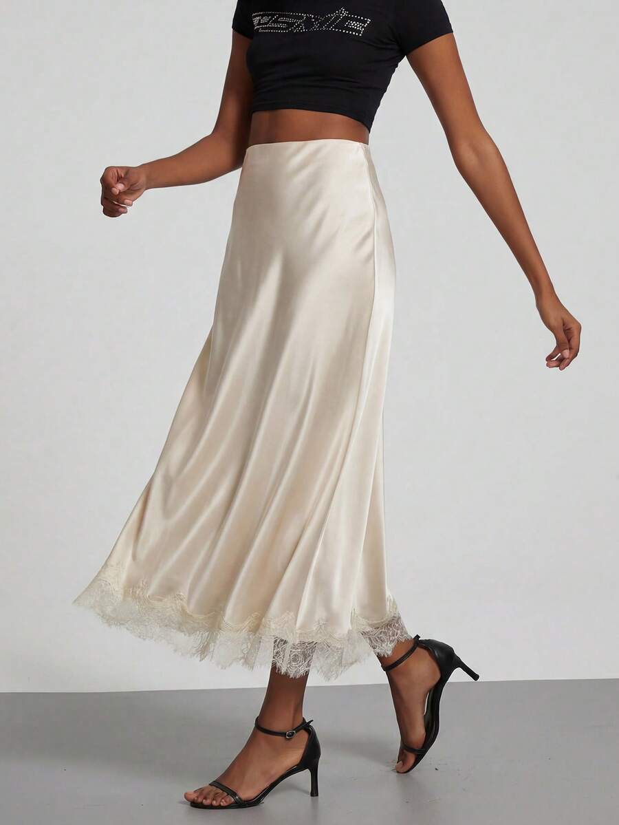 Women's black lace patchwork satin skirt featuring a long bodycon silhouette and natural mid waist design.