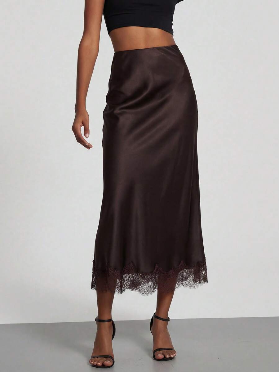 Women's black lace patchwork satin skirt featuring a long bodycon silhouette and natural mid waist design.