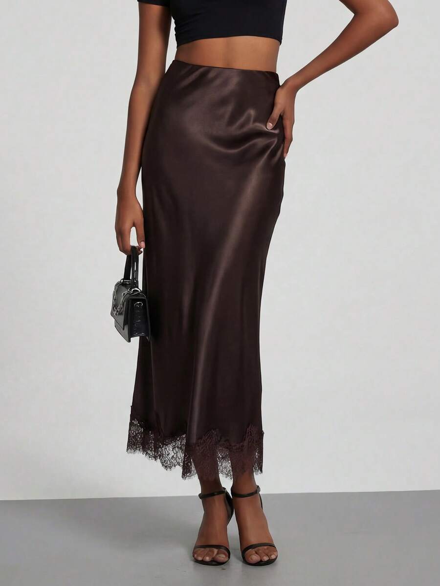 Women's black lace patchwork satin skirt featuring a long bodycon silhouette and natural mid waist design.