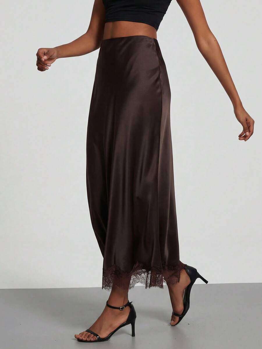 Women's black lace patchwork satin skirt featuring a long bodycon silhouette and natural mid waist design.
