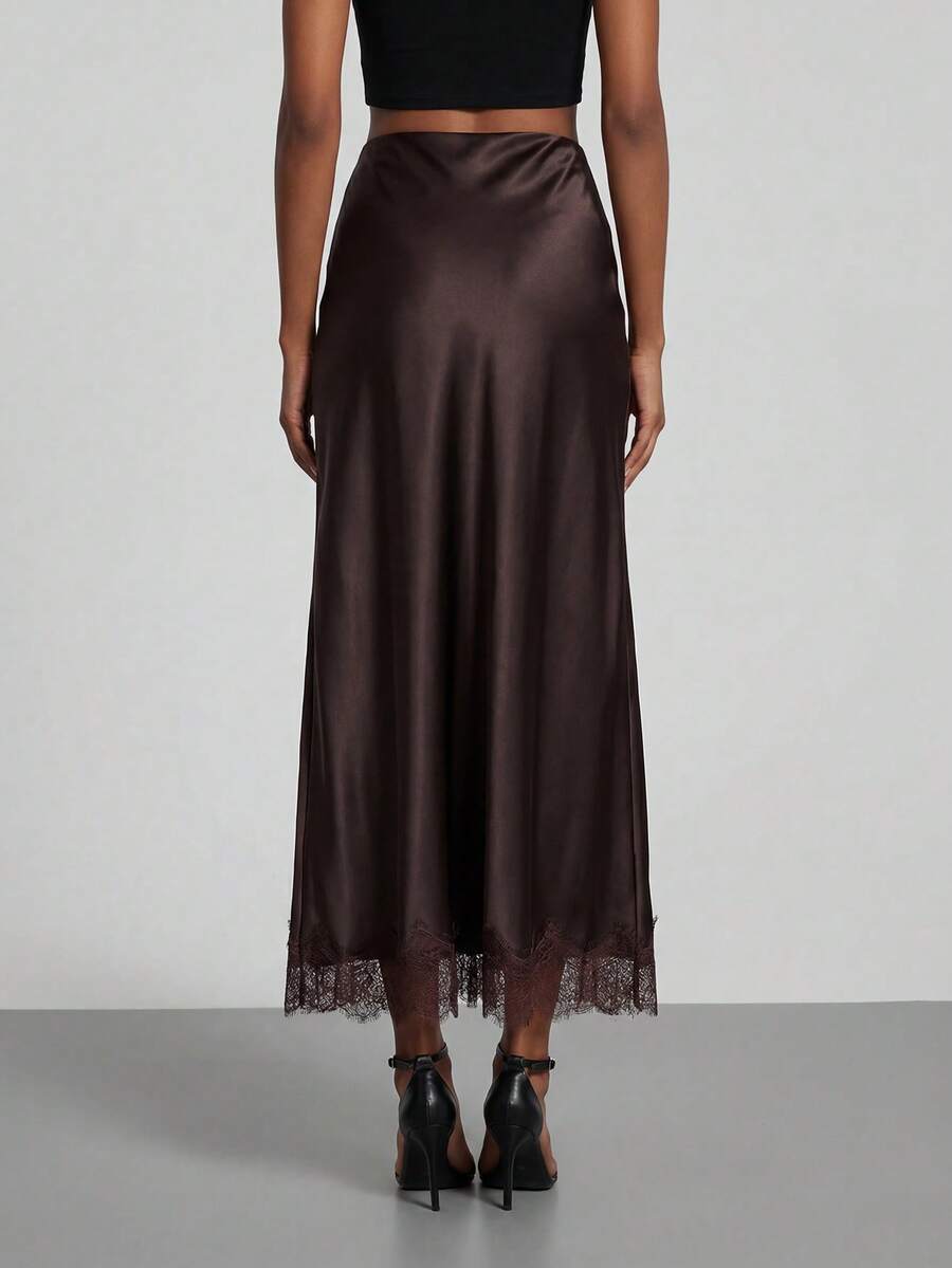 Women's black lace patchwork satin skirt featuring a long bodycon silhouette and natural mid waist design.