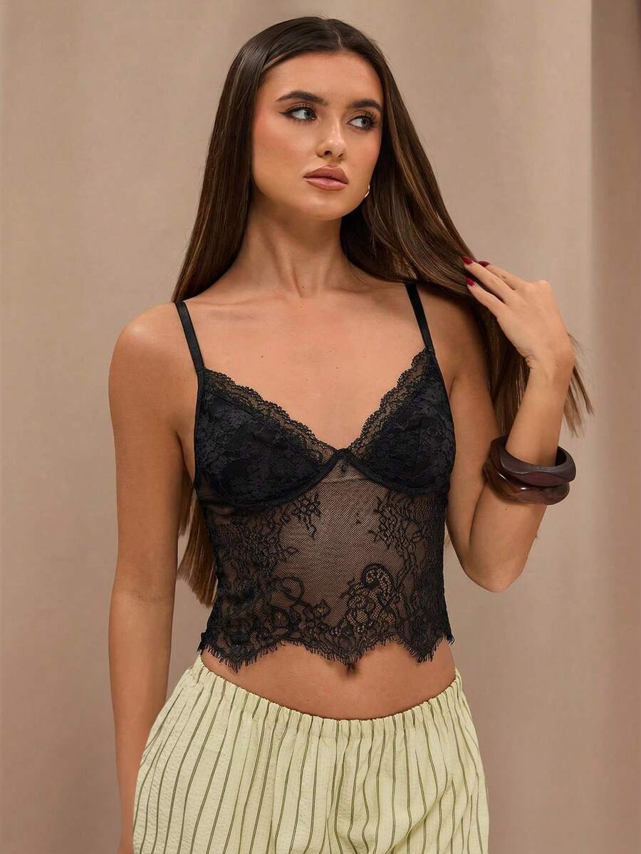 Black floral lace cropped camisole top for women featuring delicate spaghetti straps, cup detail, and semi-sheer contrast lace.