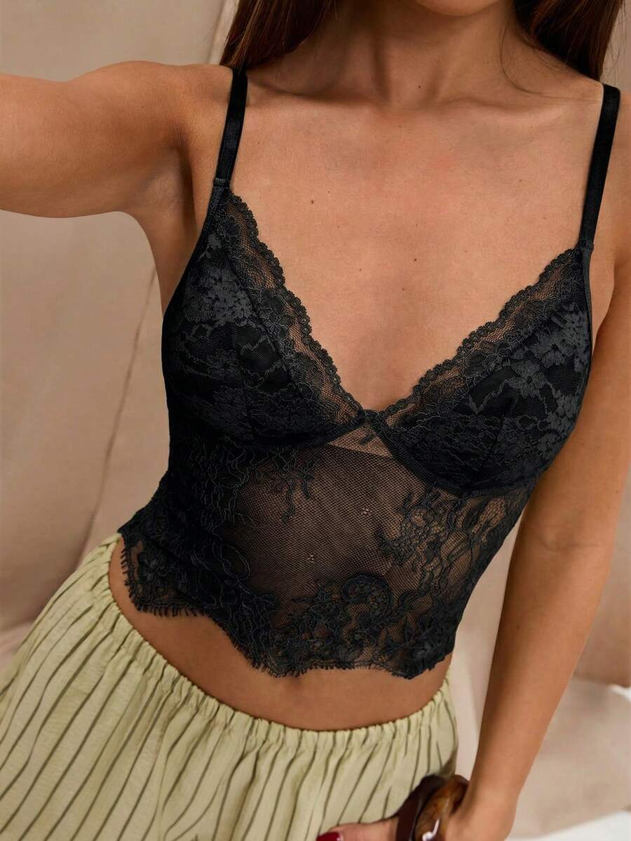 Black floral lace cropped camisole top for women featuring delicate spaghetti straps, cup detail, and semi-sheer contrast lace.