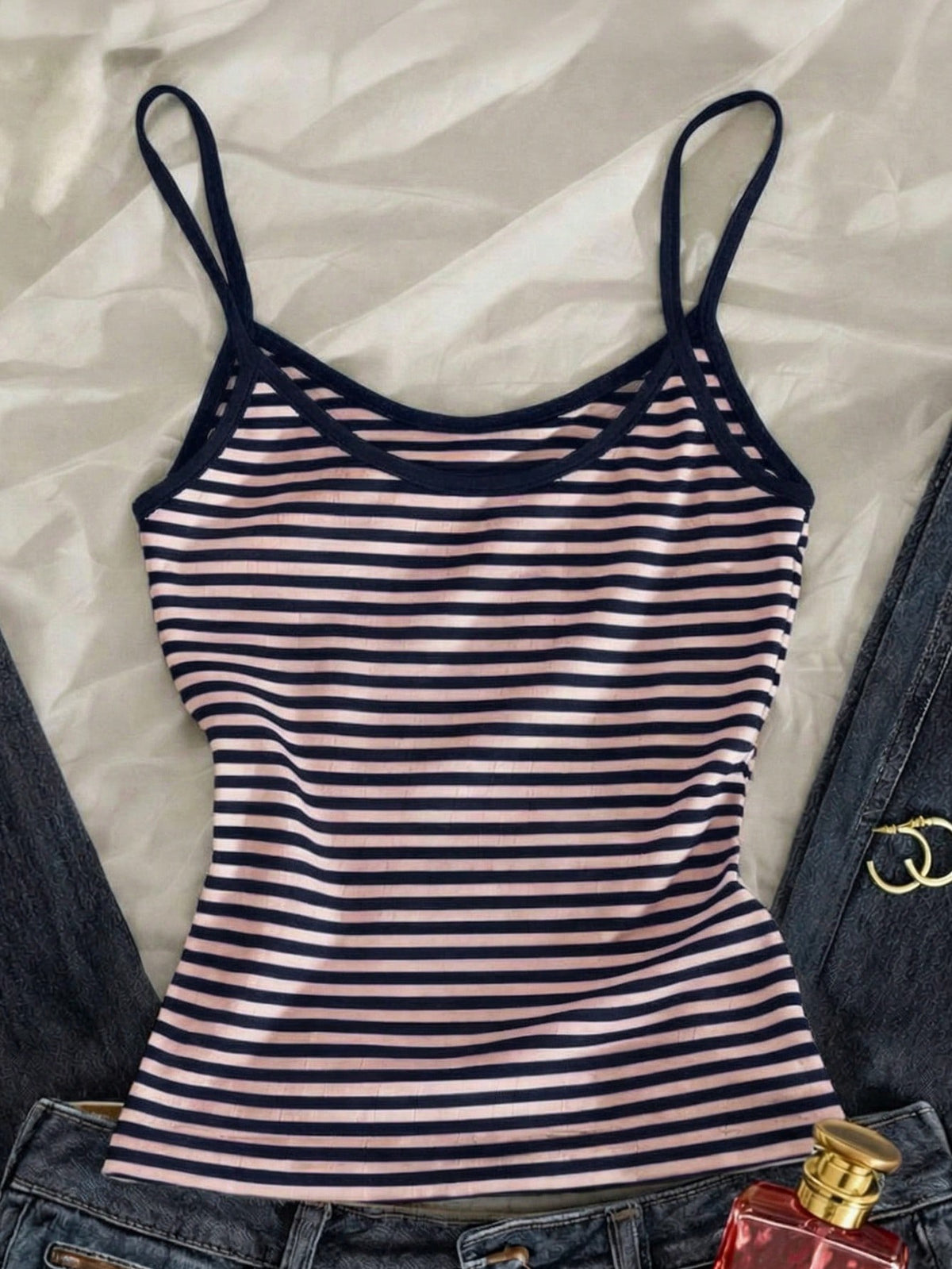Women's pink striped crop camisole featuring criss cross spaghetti straps and slim fit design.