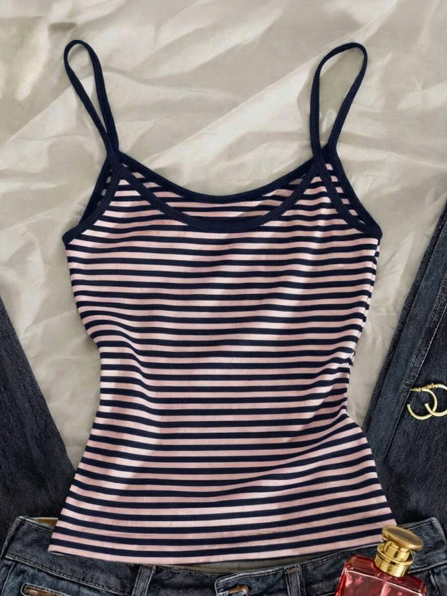 Women's pink striped crop camisole featuring criss cross spaghetti straps and slim fit design.