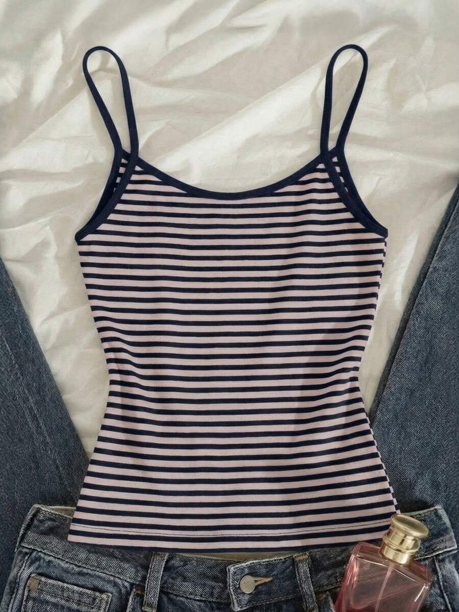 Women's pink striped crop camisole featuring criss cross spaghetti straps and slim fit design.